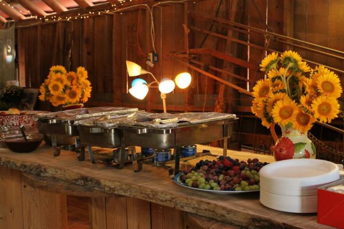 Contact us to plan your perfect wedding menu!  This table is actually a fourteen foot, rough-sawn wooden slab, cut from a giant elm tree right here at Hidden Valley Guest Ranch.  It rests on wooden spindles, offering just the right country vibe.