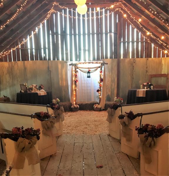 Darling antique pews moved permanently from a local chapel, adorned with Hydrangeas and burlap pew bows, setting off a Fall Wedding to perfection in the Hidden Valley Barn Loft.  Imagine every eye on you as you walk this aisle!